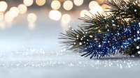 Festive winter scene with pine branch on sparkling snow surface against blurred golden bokeh lights creating magical holiday atmosphere.