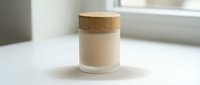 Minimalist glass jar with wooden lid on white surface in modern bathroom setting for cosmetic product storage and spa wellness applications.
