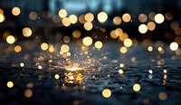 Bright sparkler burning on wet asphalt surface with golden bokeh lights creating magical atmosphere. Festive holiday celebration background with reflection.