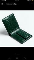 Open green crocodile leather wallet with card slots isolated on white background, ready for product design, fashion retail, and e-commerce use.