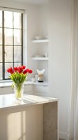 Red tulips in crystal vase on marble kitchen island with natural light from window creating elegant modern interior design for home decor and lifestyle.