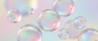 Floating soap bubbles with rainbow iridescent reflections on soft pastel background for dreamy design projects and creative concepts.