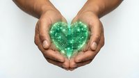 Male hands holding glowing green digital heart shape with circuit board pattern, symbolizing technology, innovation, healthcare, sustainability and digital transformation concepts.