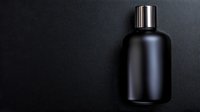 Minimalist black matte cosmetic bottle with metallic cap on dark background, elegant packaging mockup for luxury skincare and beauty products.