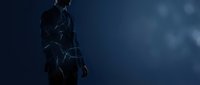 Silhouette of male figure in futuristic suit with glowing neon lines against dark blue background, suitable for sci-fi, technology, and gaming projects.