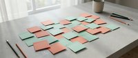 Colorful sticky notes scattered on white desk surface for brainstorming and project planning in modern office workspace with natural lighting.