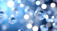 Crystal clear water droplets floating against soft blue bokeh background with sparkling light effects for wellness and purity concepts.