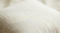 Closeup of natural linen fabric texture with soft neutral tones, showing woven fibers and material surface for textile, interior design, and fashion projects.