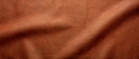 Terracotta leather texture with natural wrinkles and folds, suitable for backgrounds, design projects, fashion, upholstery, and material mockups.
