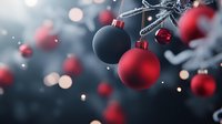 Red and black matte Christmas ornaments hanging on tree branches with soft bokeh lights and snowfall creating magical holiday atmosphere.