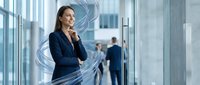 Professional businesswoman in navy suit thinking in modern office with digital technology overlay effects for corporate presentations and marketing.