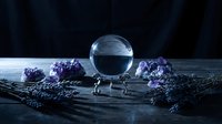 Crystal ball on dark wooden surface surrounded by amethyst crystals and dried lavender, mystical fortune telling scene.