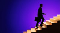 Silhouette of male professional climbing illuminated golden stairs against vibrant purple background, representing career growth, ambition, and business success for corporate advancement concepts.