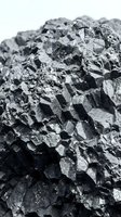 Closeup of columnar basalt rock formation with geometric crystalline structure and natural mineral texture, suitable for geology and nature backgrounds.