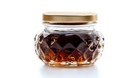 Glass jar with decorative diamond pattern texture and gold metal lid on white background, isolated product photography for packaging design and branding.