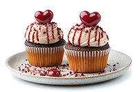 Two chocolate cupcakes with white frosting, red drizzle and heart toppers on ceramic plate. Perfect for Valentine's Day bakery menu or romantic dessert marketing.