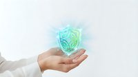 Young adult with light skin tone wearing white long-sleeved shirt holding glowing digital shield icon. Cybersecurity, data protection, and network safety concept for business presentations and technology solutions.