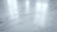Polished white marble floor with natural gray veining reflecting soft overhead lighting creating elegant shadows and highlights for luxury interior design.