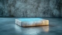 Glowing marble platform with ethereal blue light effect on dark concrete background creates mysterious atmosphere for product display presentation.