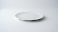 Empty white ceramic plate on clean white background isolated for kitchen dining restaurant menu design mockup presentation.