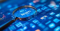 Magnifying glass focusing on word learn on digital screen with blue technology background showing data analytics and business intelligence concept.