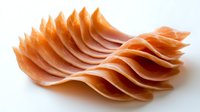 Thinly sliced ham arranged in wavy layers creating an abstract pattern on white background, showcasing delicate texture and coral-pink color gradients.