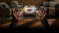 Hands creating glowing energy sphere with light effects in modern living room interior for spiritual healing and meditation concepts.