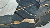 Dark gray marble with golden veins texture closeup. Natural stone surface with white cracks and streaks creates luxurious pattern for interior design background.