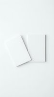 Two blank white paper sheets on white background with soft shadows for mockup design and branding projects.