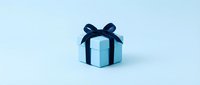 Light blue gift box with navy ribbon bow on clean white background isolated for holiday greeting cards and celebration designs.