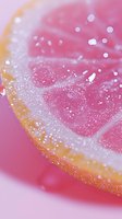 Macro shot of pink grapefruit slice with sparkling water droplets and citrus pulp texture against pink background, creating fresh and vibrant summer drink visual.