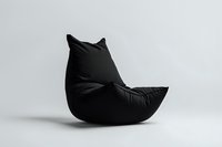 Modern black bean bag chair shaped like cat silhouette against light background, minimalist furniture design for contemporary interior spaces.