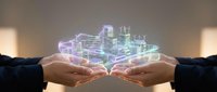 Two businesspeople holding a glowing holographic cityscape between their hands, representing urban development, smart city technology, and collaborative innovation for future planning.
