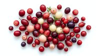 Red and pink grapes isolated on white background, fresh fruit collection in various shades for food, nutrition, and culinary design projects.