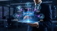 Professional businessman presenting holographic up-selling strategy with digital marketing icons and network connections for business growth and sales optimization.