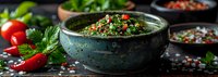 Fresh tabbouleh salad with bulgur wheat, parsley, mint and tomatoes served in rustic ceramic bowl, middle eastern cuisine perfect for healthy menu photography.