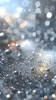 Magical silver and blue bokeh background with water drops and glowing particles creating dreamy atmospheric effect for luxury designs and festive layouts.