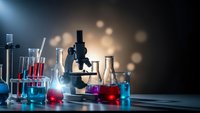 Laboratory equipment with microscope and colorful chemical solutions in glassware for scientific research and experimentation in modern lab setting.