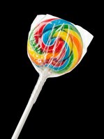 Rainbow swirl lollipop in plastic wrap, isolated on transparent background. Great for candy clipart, stickers, t-shirt design, print on demand, and sublimation projects.