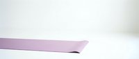 Isolated lavender ribbon with curved edge on white background, ready for design projects, invitations, gift wrapping, and craft applications.