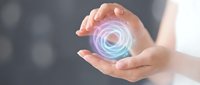 Hands protecting glowing digital energy sphere with circular light effects for technology and innovation concepts in business presentations.
