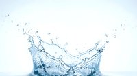 Water splash with droplets frozen in motion against white background, suitable for beverage, refreshment and wellness design projects.