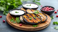 Grilled eggplant slices with yogurt sauce and pomegranate seeds on wooden board. Mediterranean appetizer garnished with fresh parsley leaves and dips.