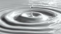 Water drop creating ripples on calm surface with concentric circles in monochrome style for wellness and purity concepts in advertising and design projects.