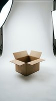 Empty brown cardboard shipping box open on white studio background with professional lighting setup for product photography and commercial use.