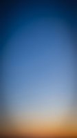 Abstract gradient background transitioning from deep blue to warm orange, smooth color blend for modern design projects and digital presentations.