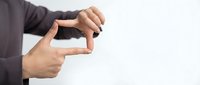 Professional businessman hands forming rectangular frame gesture for creative vision and planning concepts on white background.