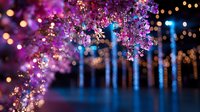 Magical evening scene with pink cherry blossoms against blurred blue lights and bokeh background creates dreamy spring atmosphere for romantic designs and celebrations.