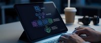 Professional using tablet displaying colorful AI and machine learning interface icons in modern office workspace with coffee cup and headphones nearby.