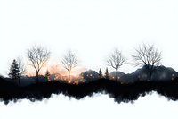 Dramatic winter landscape silhouette with bare trees and mountain range reflecting in calm water at sunset, moody nature scene with fog and clouds.